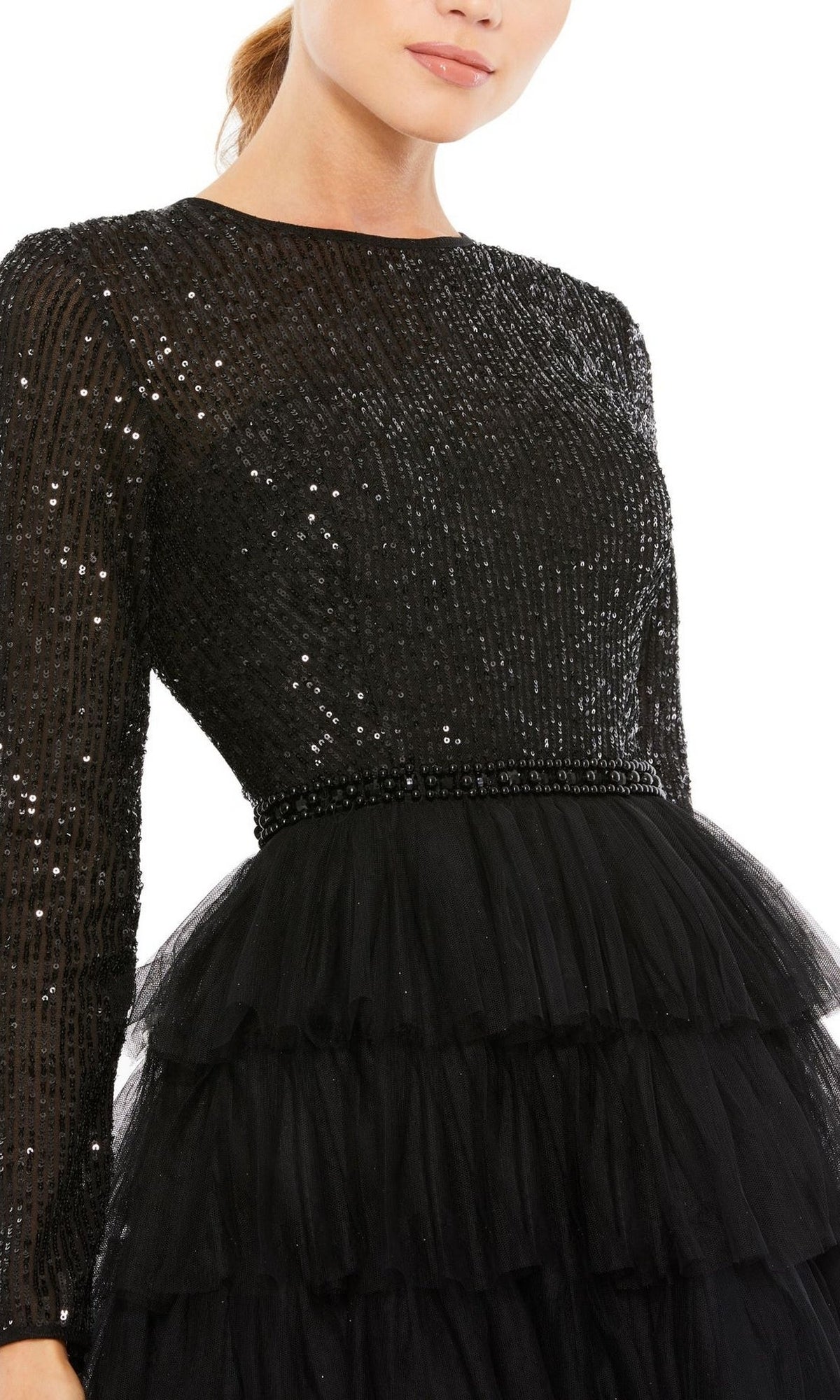 Someone wearing the Mac Duggal 26299 knee-length wedding guest dress—a black, long sleeve party dress with sequin top and layered tulle skirt—makes a chic statement for any special occasion.